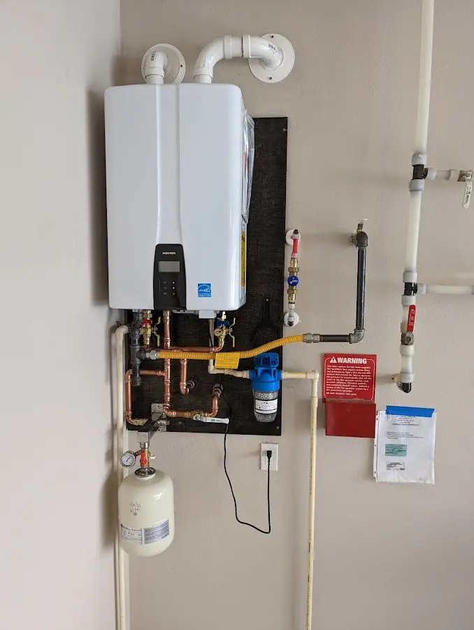 Professional plumber installing copper piping in a Wadena home
